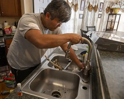 Five Star Services technician performing a professional faucet installation in Richmond, VA, ensuring smooth and leak-free operation for a homeowner.